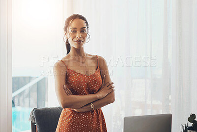 Buy stock photo Cropped portrait of an attractive young businesswoman standing with her arms crossed in her home office