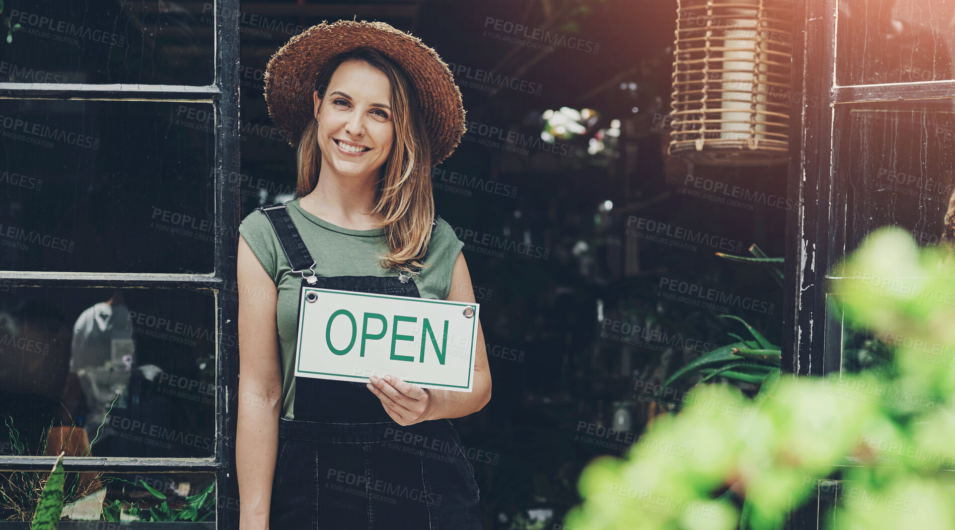 Buy stock photo Full length portrait of an attractive young business owner standing alone and holding the open sign at the floristry entrance