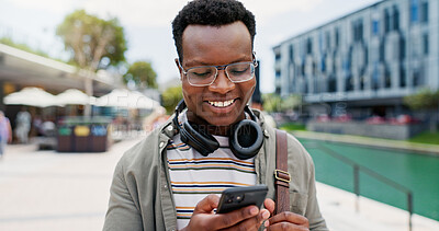 Buy stock photo Phone, smile and black man student in city reading email for university scholarship approval. Happy, technology and African male person with smartphone for online college results achievement in town.