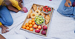 People, blanket and picnic with fruit, top view and snack with nutrition, relax and bonding together. Closeup, group and friends with organic food, delicious and outdoor with croissant or charcuterie
