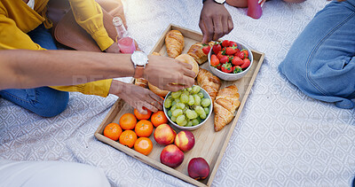 Buy stock photo Food, hands and picnic with friends on blanket from above, outdoor together for bonding or eating. Fruit, health or wellness with group of people in summer for green and organic diet or nutrition