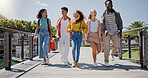 Walking, conversation and friends at university with fun for learning, bonding and talking. People, diversity and group of gen z students on outdoor bridge ready for education at college campus.