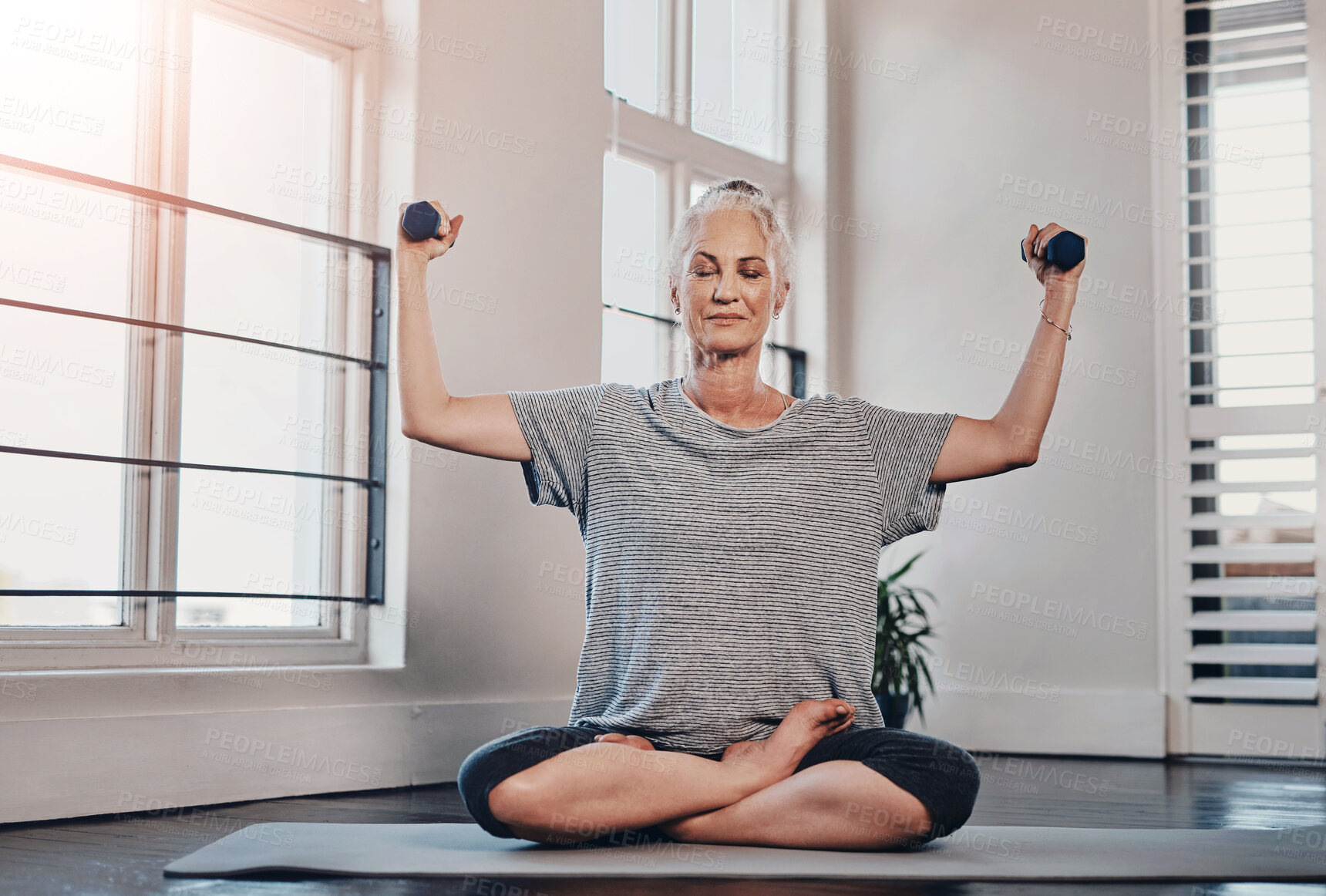 Buy stock photo Portrait of a cheerful mature woman practicing yoga while making use of weights inside of a studio during the day