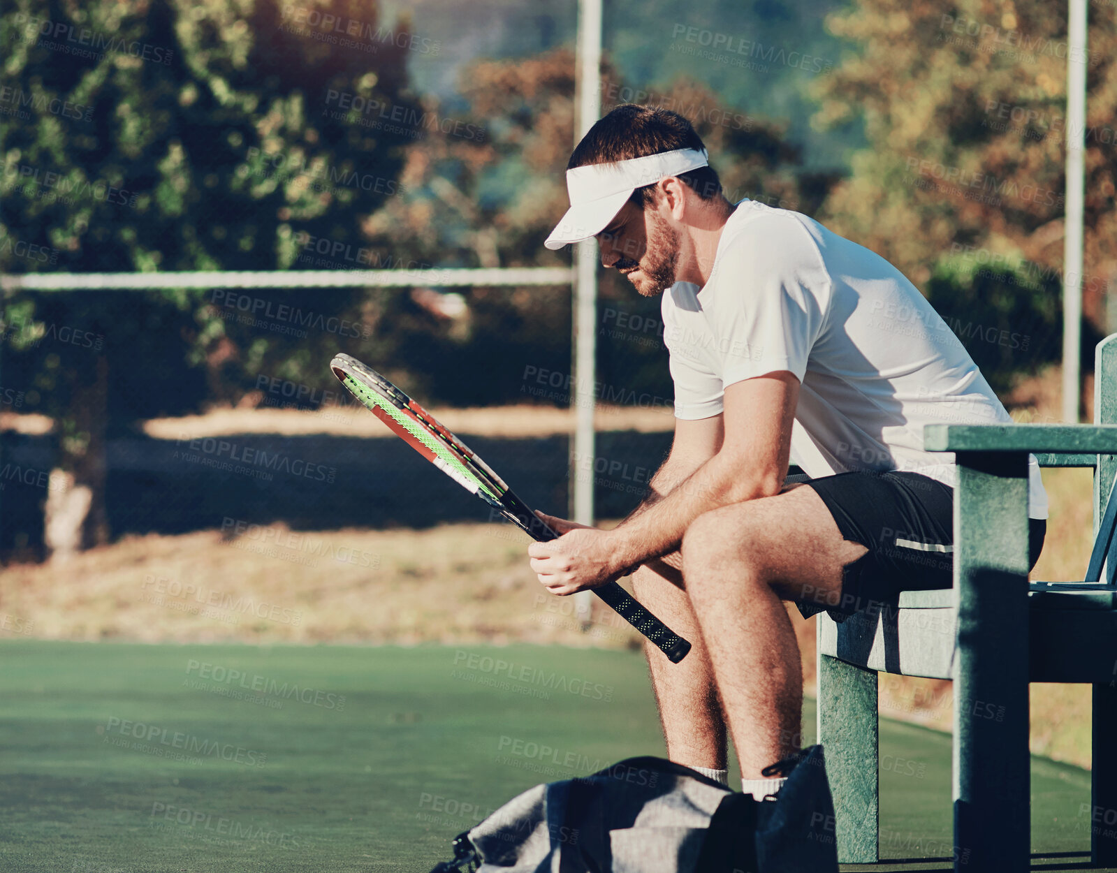 Buy stock photo Man, tennis and racket on bench at fitness club for outdoor competition, exercise and training for match. Athlete, workout and professional sports on court for thinking, waiting or planning game play