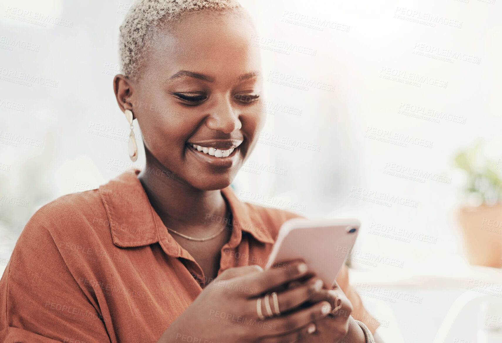 Buy stock photo Shot of a young businesswoman using a cellphone in an office