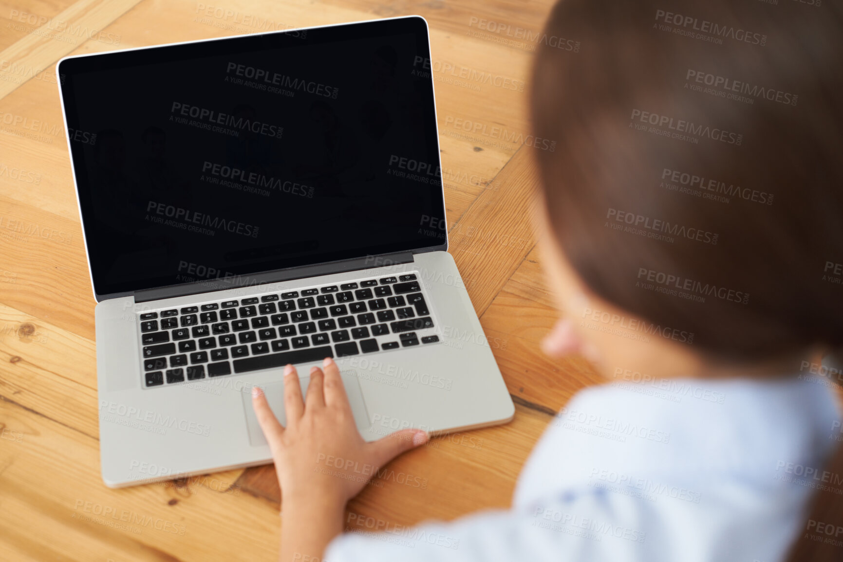 Buy stock photo Rear view of a young businesswoman in a video conference with her colleagues