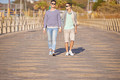 Buy stock photo Couple, gay and men with holding hands for walk, sunglasses and summer on promenade. Male people, honeymoon and strolling for beach vacation with partners, supportive and together in Cape Town