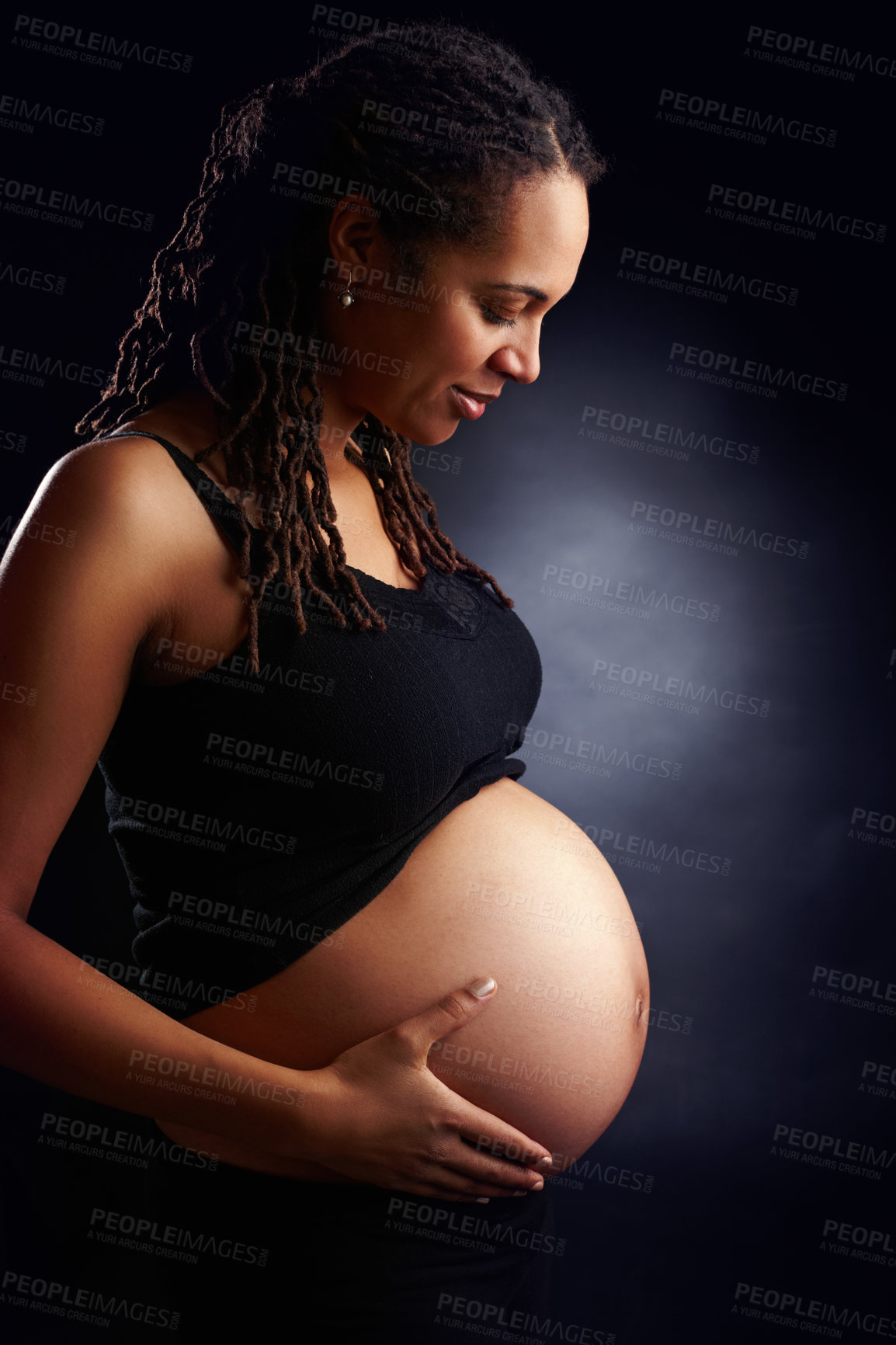 Buy stock photo Pregnant, mom and care with stomach in studio, baby bump and woman in pregnancy. Black background, gestation and gynecology for belly growth, maternity wellness and motherhood for family planning