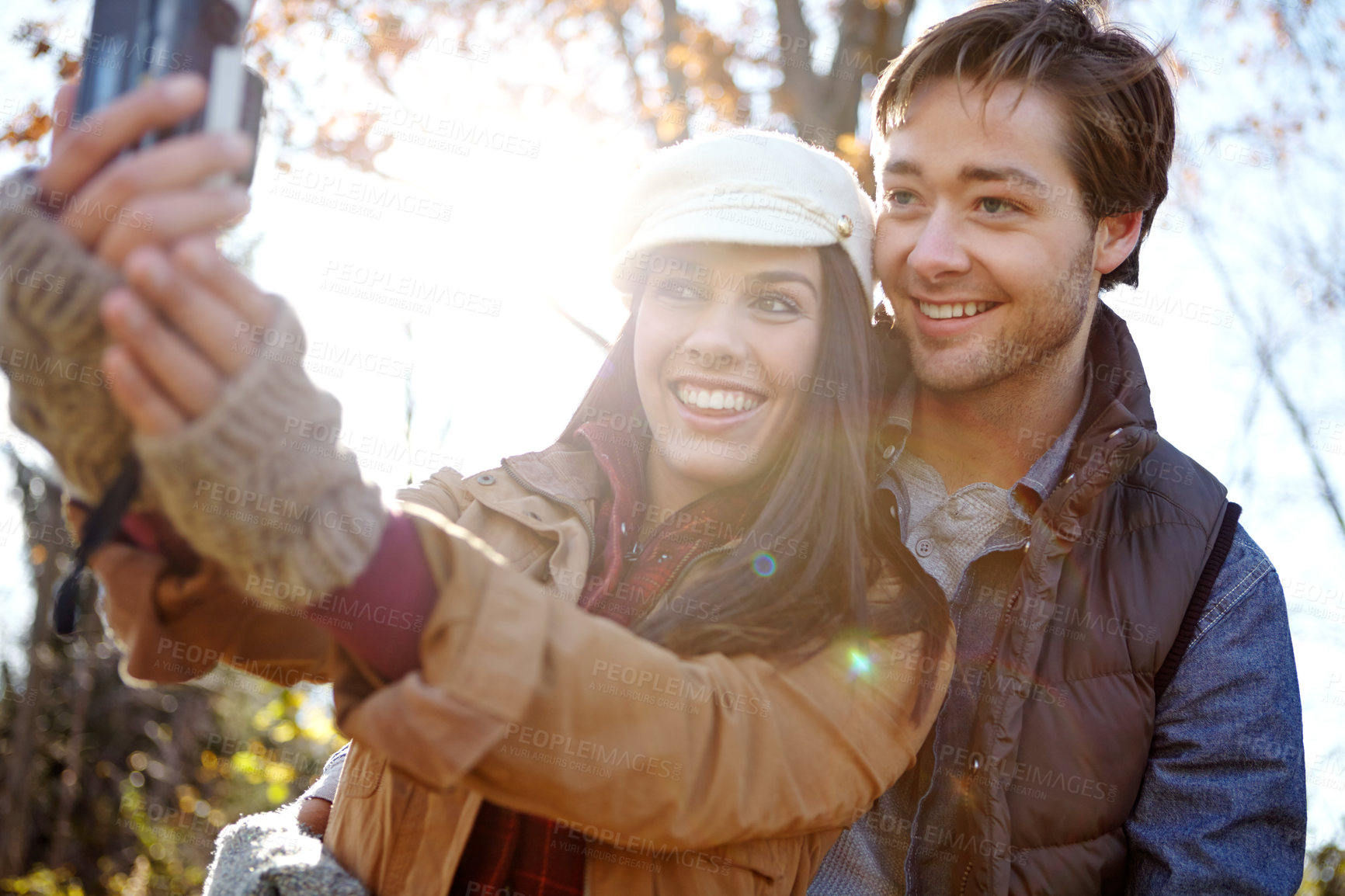 Buy stock photo People, couple and happy in park with selfie for social media or profile picture as nature lovers in Germany. Relationship, love and smile in forest on winter holiday, sightseeing and adventure