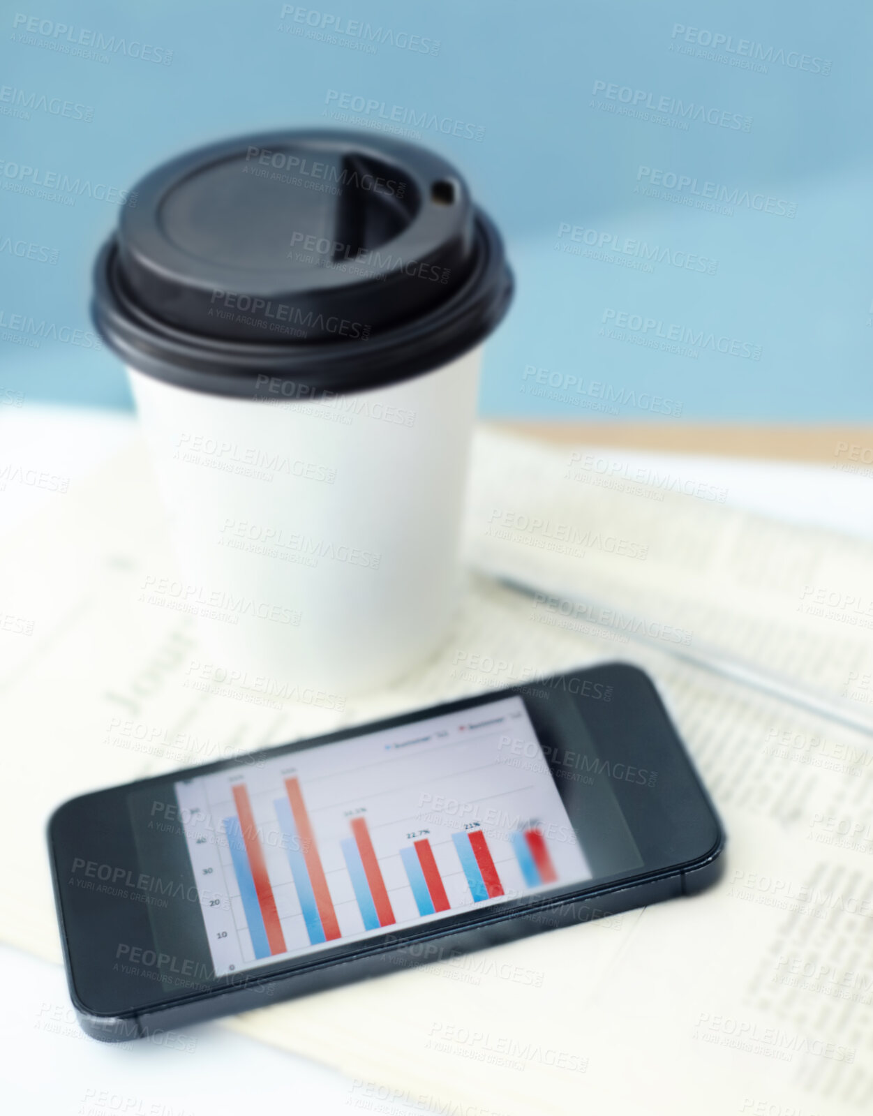 Buy stock photo Coffee, business newspaper and empty office with smartphone at company closeup. Cup, drink and news journal with phone on desk for data statistics, screen or pen in room interior design in top view