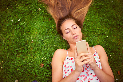 Buy stock photo Relax, woman and smartphone on grass for chat, research and blog or website on campus. College student, technology and scroll in backyard or field for network, online and social media or notification