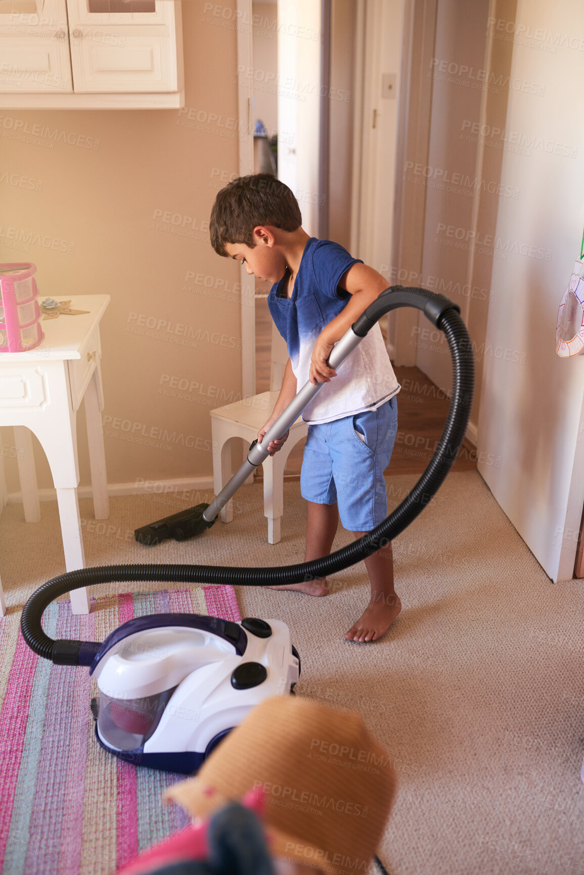 Buy stock photo Shot of a little boy vacuuming his bedroom at home