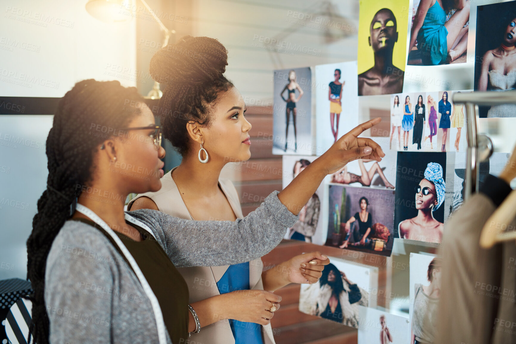 Buy stock photo Shot of two young designers collaborating on a new design