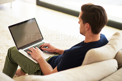 Buy stock photo Sofa, screen and man with laptop in home for information, freelance project and digital report. High angle, remote work and male person with tech for communication, connection and copywriting website