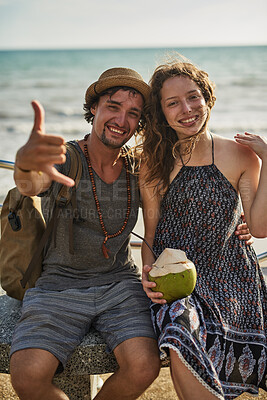 Buy stock photo Portrait, couple and hug at beach on vacation, alcohol and travel to Bali for tropical drink at sea. People, relax and hang loose emoji in outdoor nature, love and together for holiday by ocean