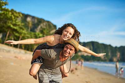 Buy stock photo Happy couple, piggyback and portrait on beach for airplane, love and vacation on tropical island. Man, woman and together by ocean for holiday, travel and adventure in sunshine on seaside in summer