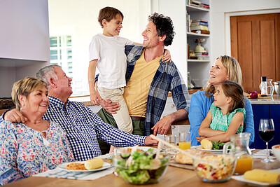 Buy stock photo Lunch, happy family and food in living room for nutrition, bonding and healthy meal and drink. Parents, kids and grandparents with smile at table for gathering, feast and wellness together at home