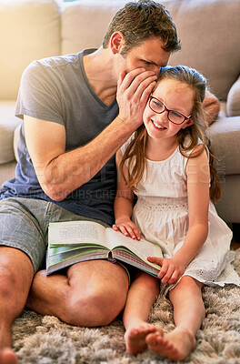 Buy stock photo Child, father and secret of reading books in living room with education, youth development and knowledge. Smile, whisper and gossip with a child and parent together with love, bonding and smile