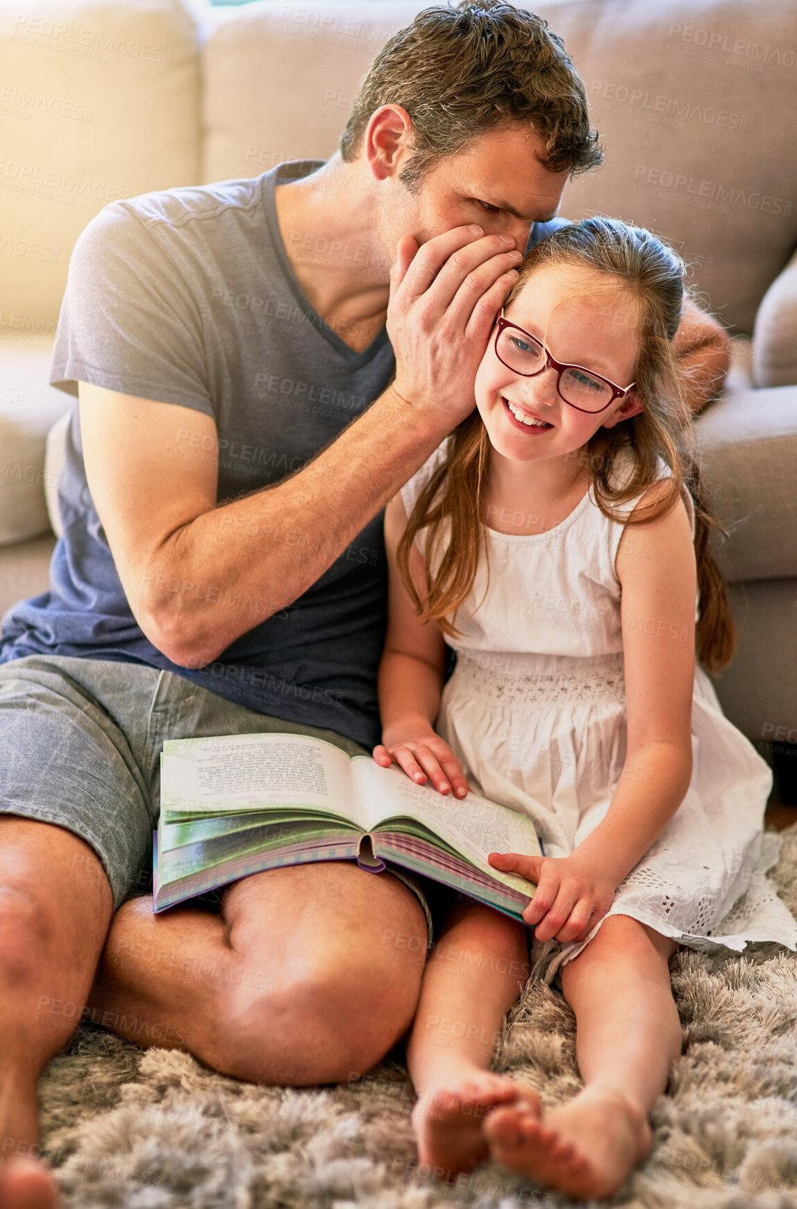 Buy stock photo Child, father and secret of reading books in living room with education, youth development and knowledge. Smile, whisper and gossip with a child and parent together with love, bonding and smile