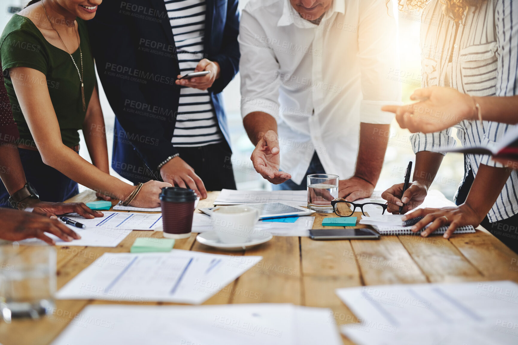 Buy stock photo Shot of a group of unrecognizable people working together in a modern office