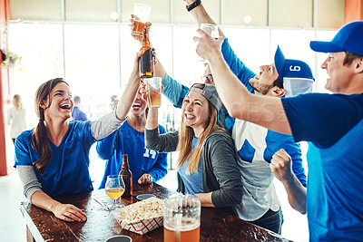 Buy stock photo Shot of a group of friends watching their favorite team live in a sports bar