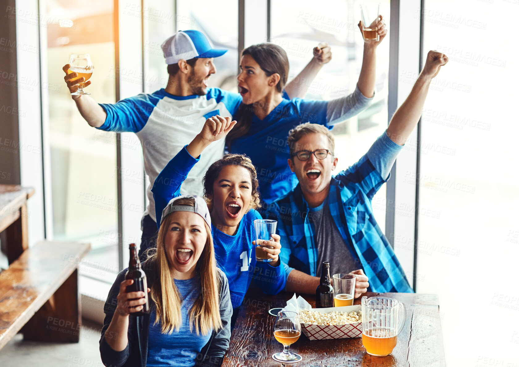 Buy stock photo Portrait, supporters and celebration for goal at pub, cheering for victory in sports on television for team. Group, fans and beer for soccer, tournament or match as friends with loyalty in world cup