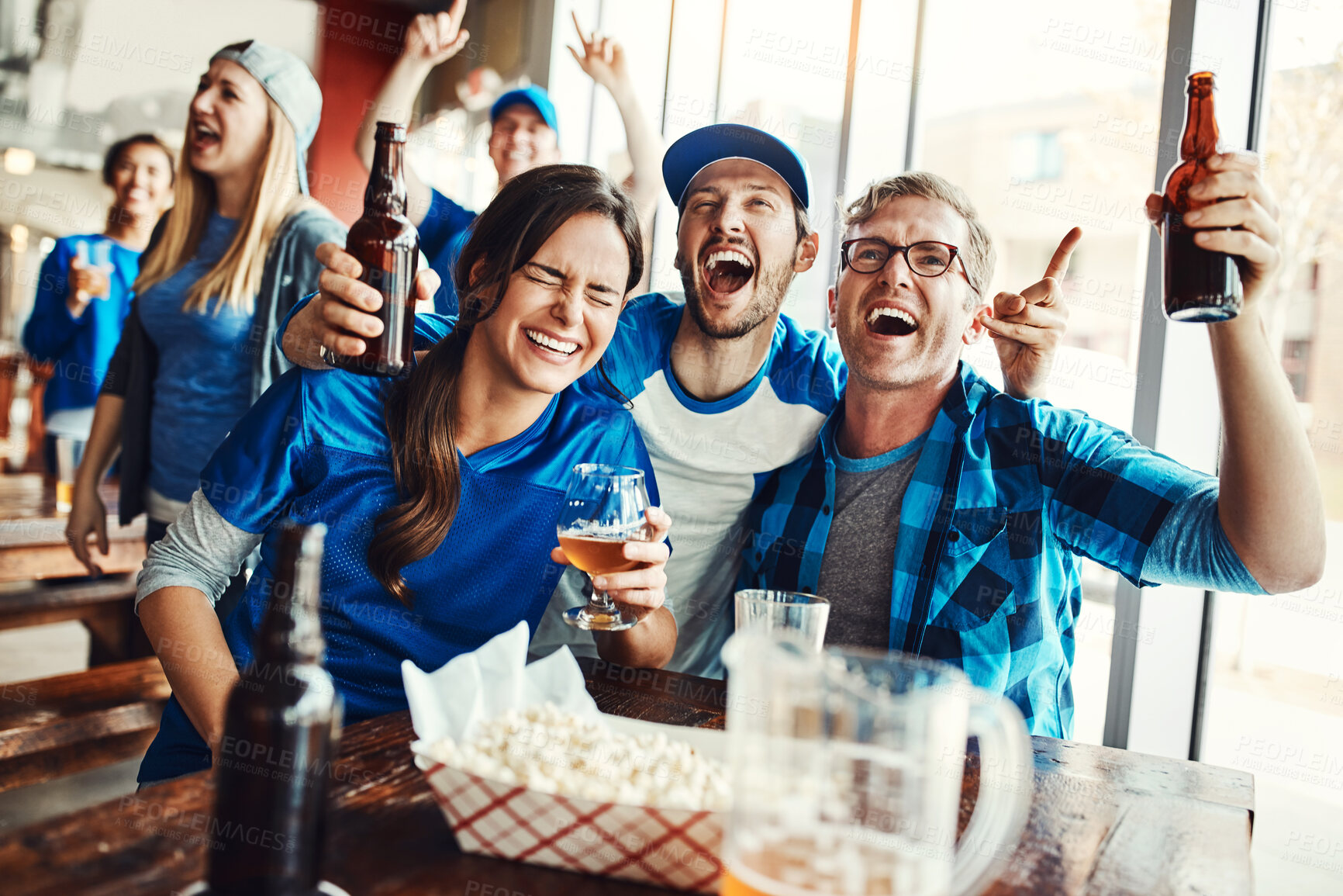 Buy stock photo Friends, happy and sports game success, tournament victory and celebration of football league match event. Men, cheering and woman for support, fan and winning with beer of score achievement at pub