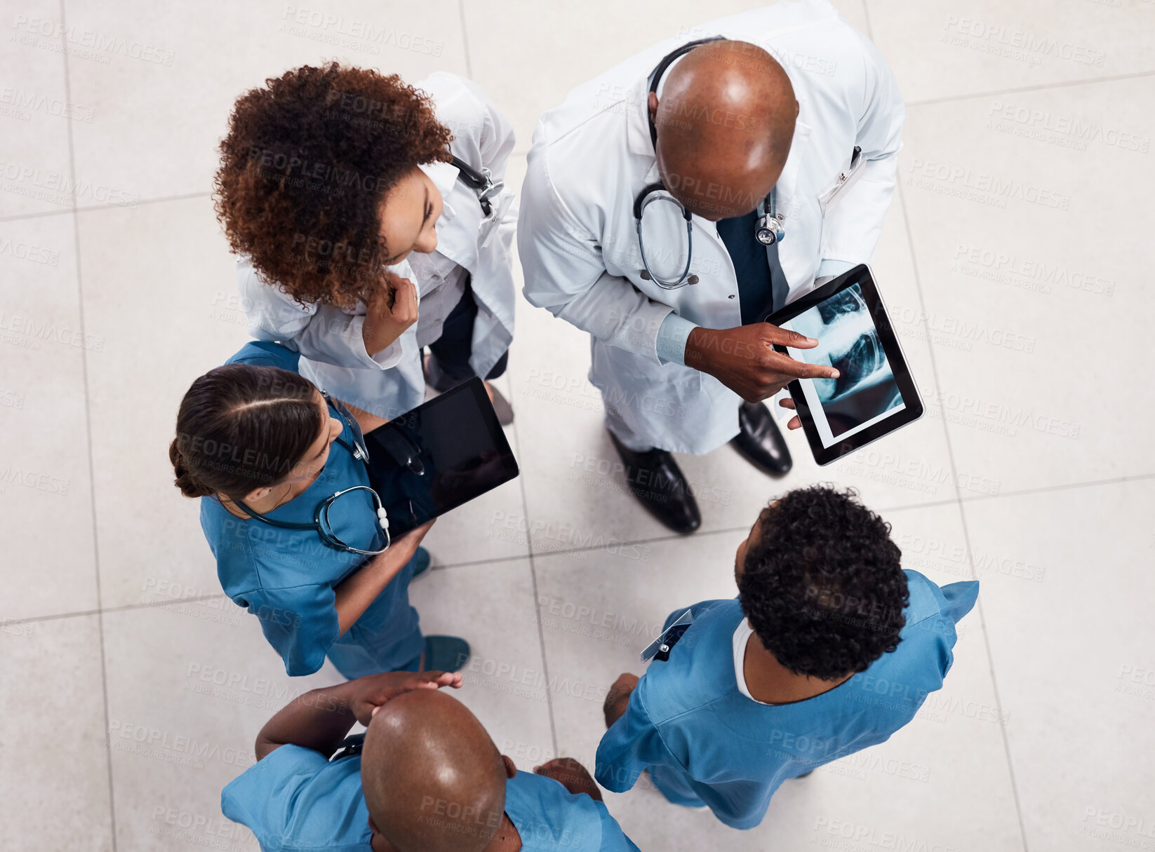 Buy stock photo Top view, advice and doctors with tablet screen, xray and teamwork for surgery analysis in hospital. Conversation, medical and professional with tech, help and collaboration for healthcare people