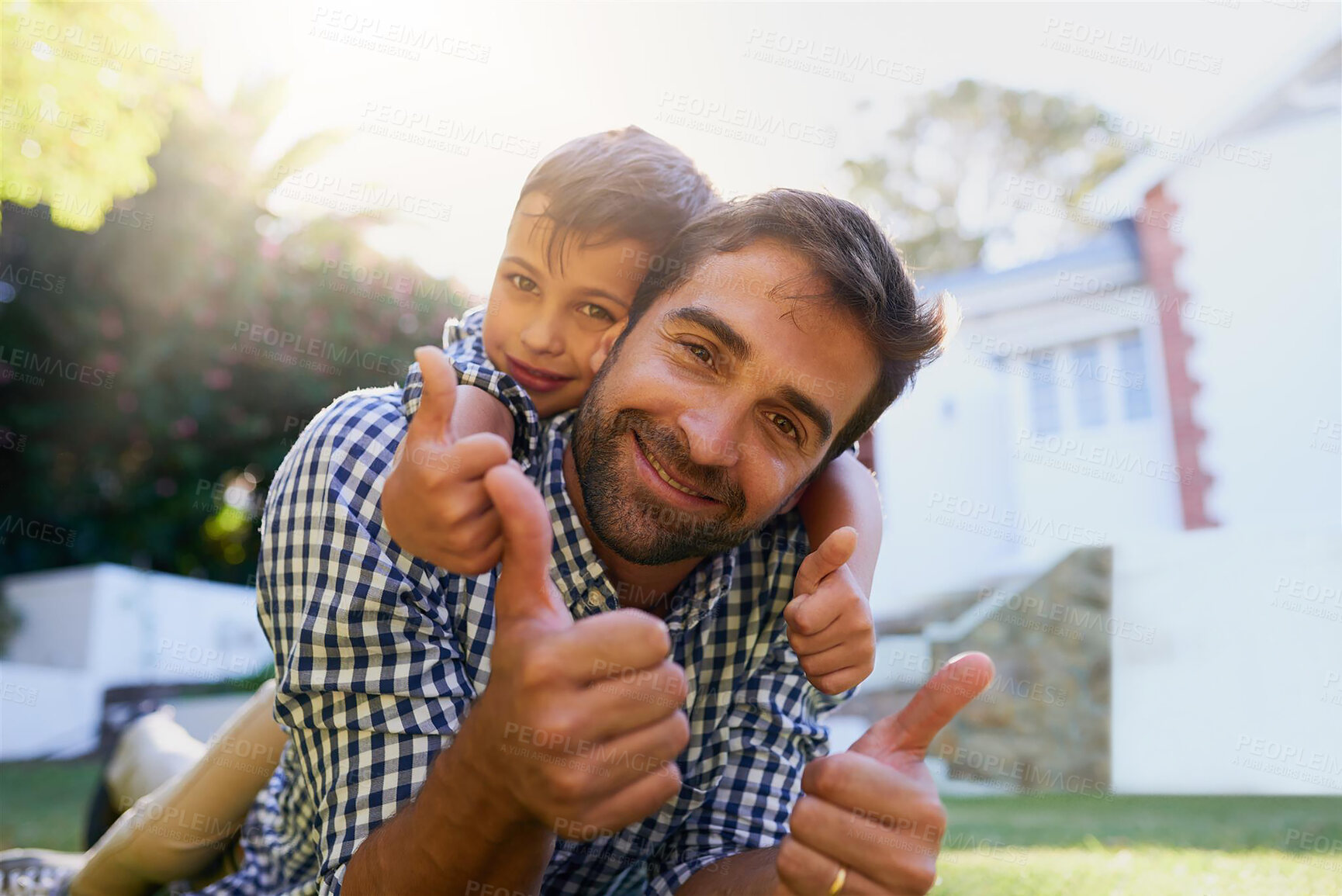 Buy stock photo Father, son and portrait with thumbs up outdoor with hugging, smile or bonding together on grass. Happy people, yes emoji or greeting with embrace in backyard of house for playing, relax or parenting