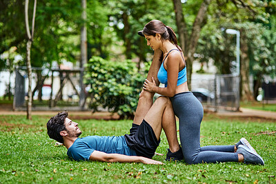 Buy stock photo Stretch, couple and park for workout, legs and hamstring for cardio or run club. Discussion, fitness and warm up for training together and married people, exercise and trees for marathon preparation