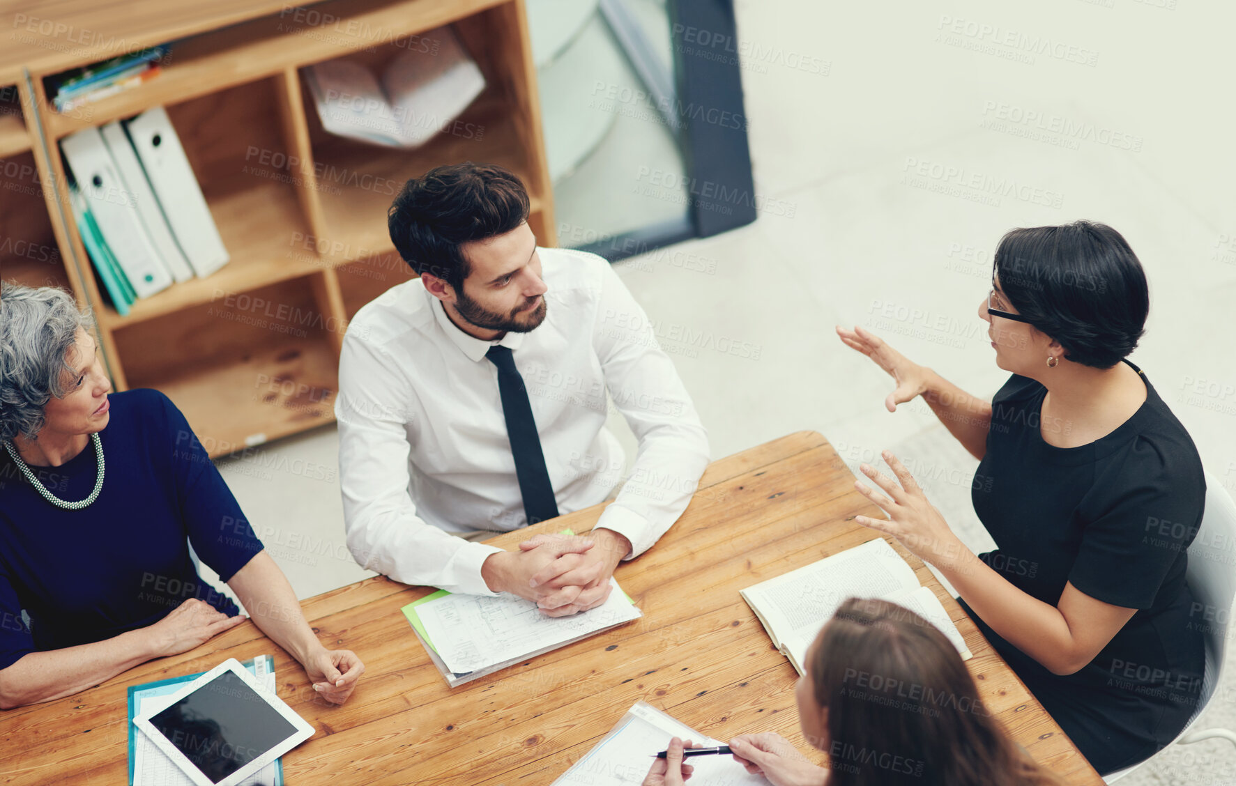 Buy stock photo High angle shot of a group of businesspeople having a meeting in an office