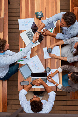 Buy stock photo Deal, planning and business people with handshake at workshop for data analysis, stats and tech project. Laptop, paperwork and team shaking hands with charts, graphs and b2b collaboration from above