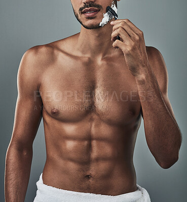 Buy stock photo Grooming, man and shaving face in studio in topless, abs and epilation on gray background. Male person, skincare and razor for hair removal with healthy body, six pack and routine or transformation