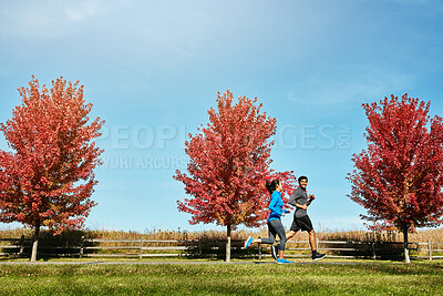 Buy stock photo Happy couple, running and outdoor cardio with partner in nature for workout or exercise together. Fitness man, woman or runners enjoying sprint, race or jog for health on road or path in countryside