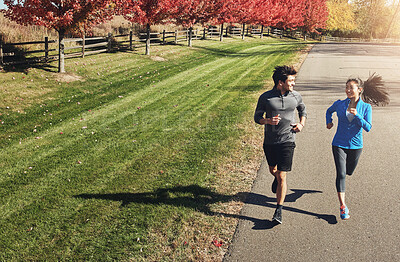 Buy stock photo Happy couple, running and workout with partner in nature for fitness, exercise or cardio together. Active man, woman or runners with smile and enjoying sprint, race or jog on road in countryside