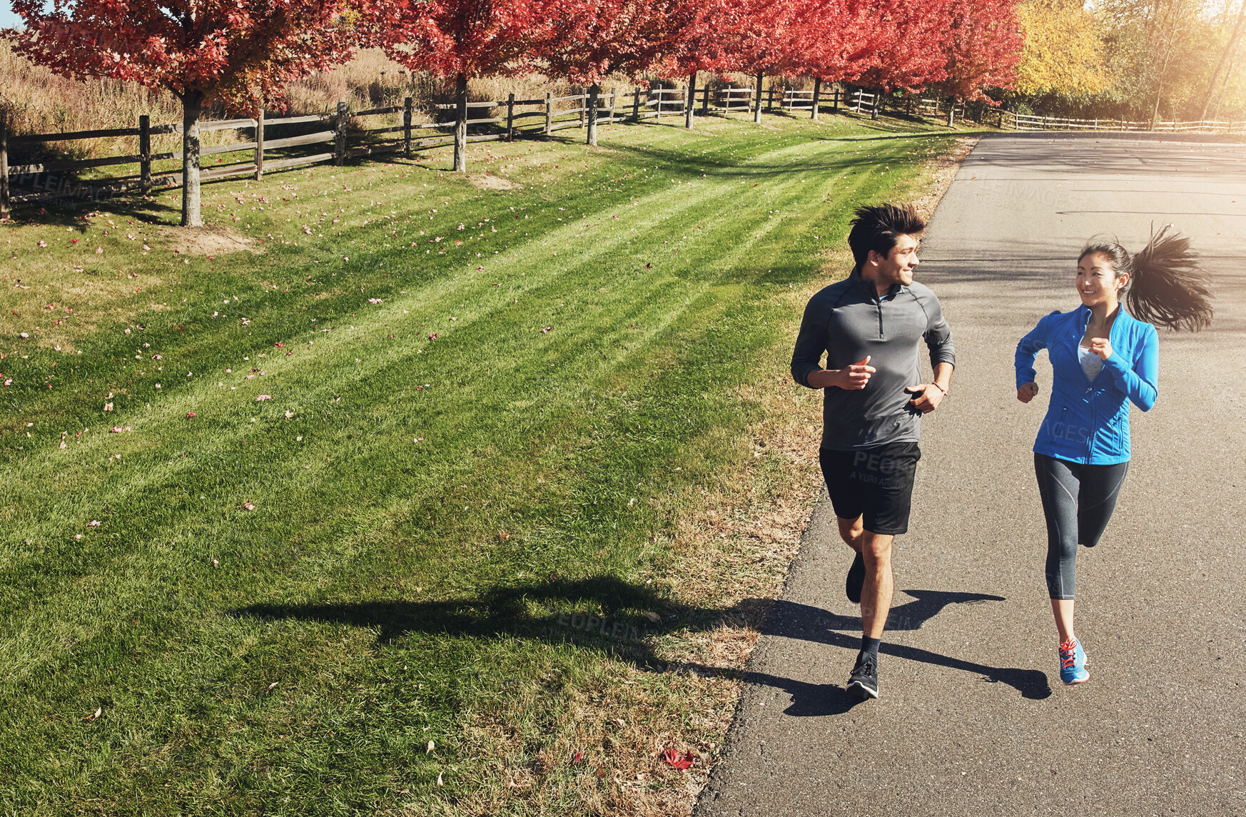 Buy stock photo Happy couple, running and workout with partner in nature for fitness, exercise or cardio together. Active man, woman or runners with smile and enjoying sprint, race or jog on road in countryside