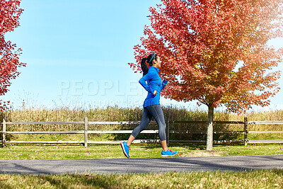 Buy stock photo Happy woman, running and fitness with autumn trees in countryside for workout, outdoor exercise or cardio. Active female person, athlete or runner on jog for training, health and wellness in nature