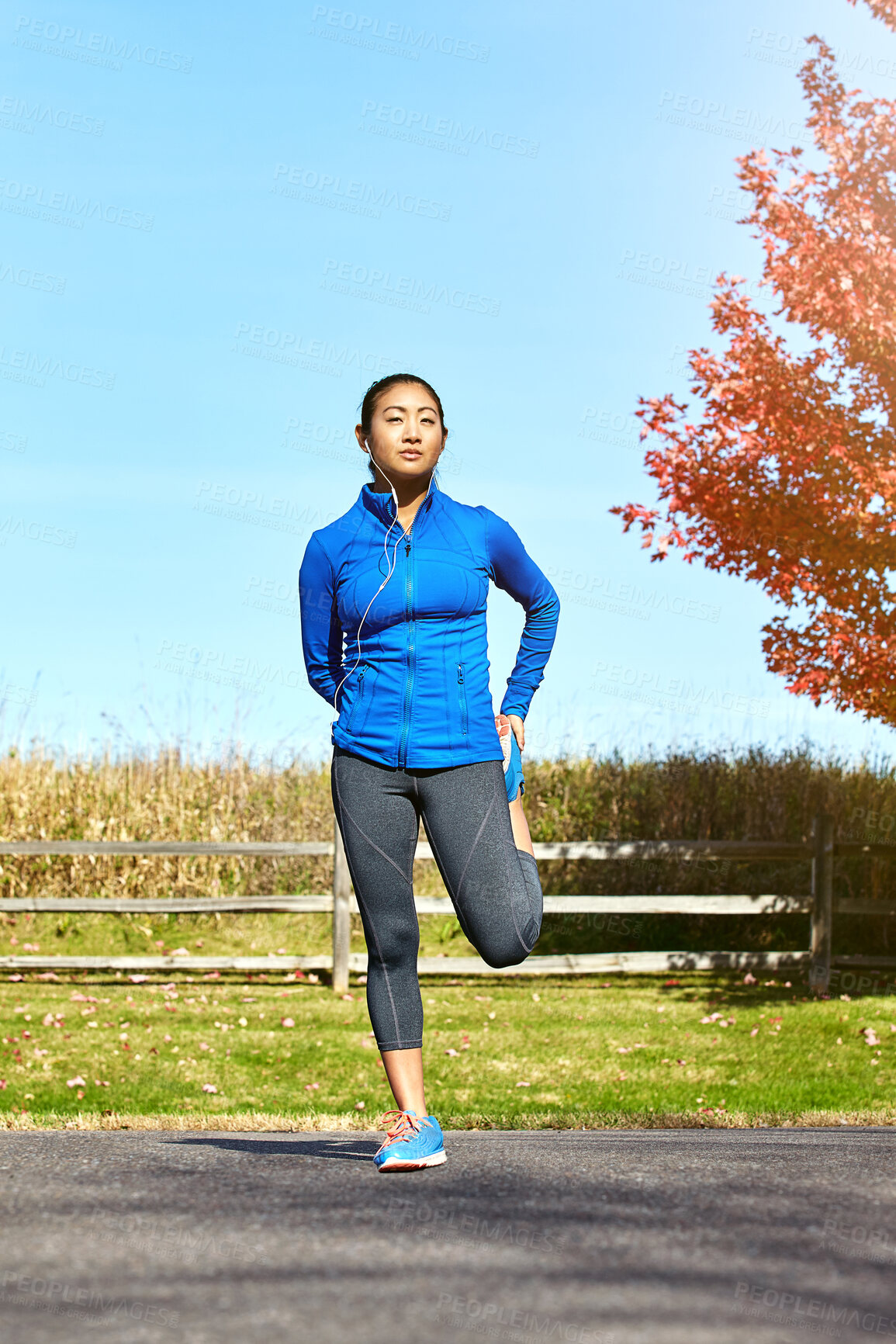 Buy stock photo Asian woman, fitness and stretching with earphones for music, workout or outdoor training in countryside. Female person, athlete or runner in warm up, preparation or getting ready for cardio exercise