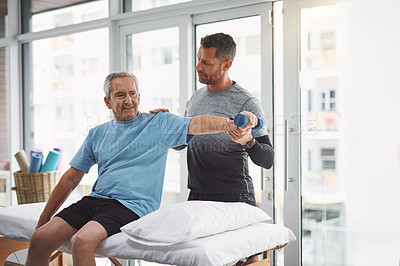 Buy stock photo Physio, dumbbell and senior man with rehabilitation, arm muscle and check in clinic. Consultation, client and elderly care with physical therapy, wellness and injury support with chiropractor