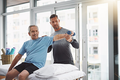 Buy stock photo Physio, dumbbell and senior man with arm rehabilitation, help and healthcare check in clinic. Consultation, client and care with physical therapy, wellness and injury support with chiropractor