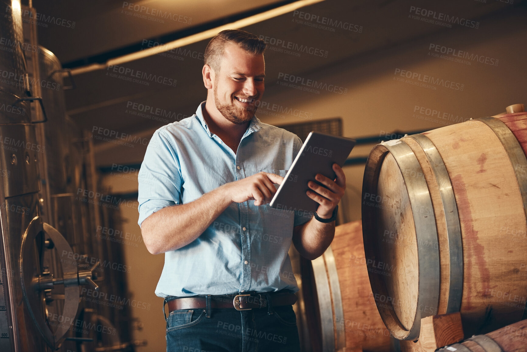 Buy stock photo Business, man and proud with tablet in brewery as manager with smile on product, process and schedule for supplier. Employee, barrel and happy for beer production, manufacturing or craft in factory