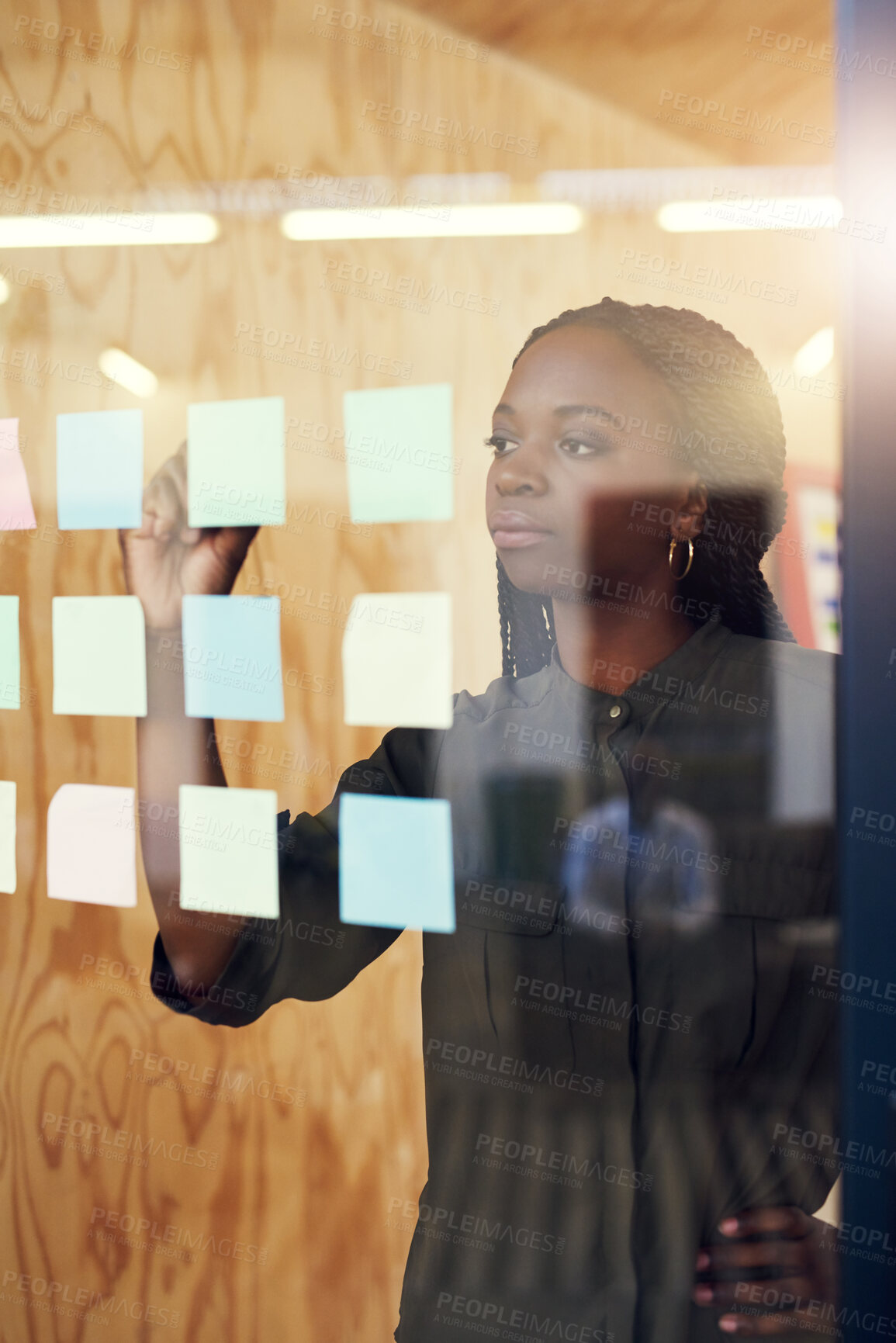 Buy stock photo Black woman, writing and ideas on glass at startup for brainstorming, sticky note and planning in office. African employee, person and moodboard with thinking, mindmap and vision at creative agency