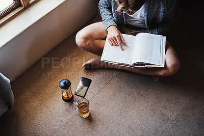 Buy stock photo Relax, reading and man with book on floor for knowledge, entertainment or story in living room. Morning, high angle and person with cup of tea for information, hobby or studying literature in home