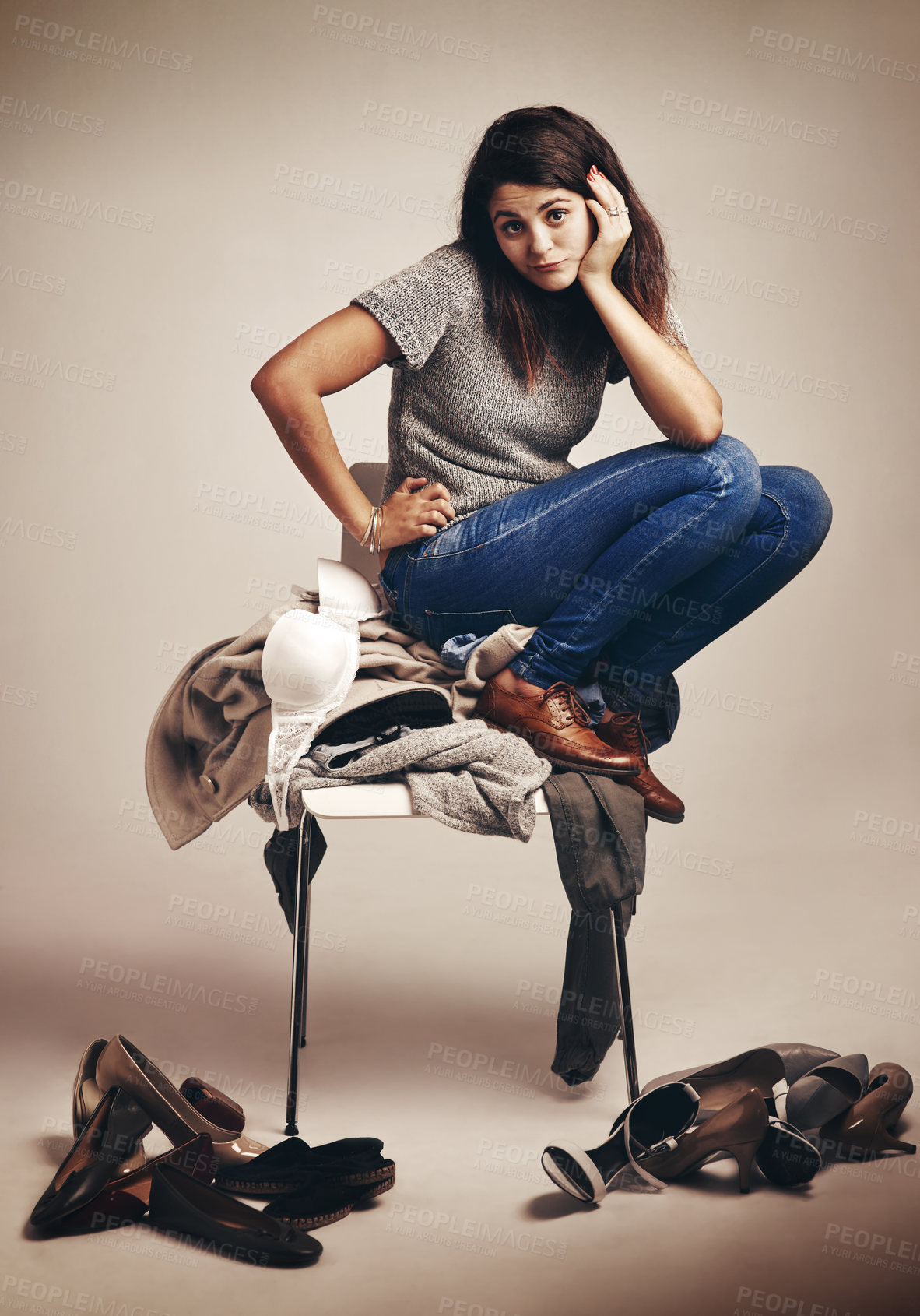 Buy stock photo Fashion, doubt and woman with pile of clothes for outfit choice, decision or option with mess. Thinking, uncertain and portrait of female shopaholic with chaos with clothing by studio background.