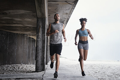 Buy stock photo Sports, running and people with speed at beach for workout, marathon training or endurance challenge. Fitness, wellness and athlete man with woman for morning cardio, energy or race in Brighton