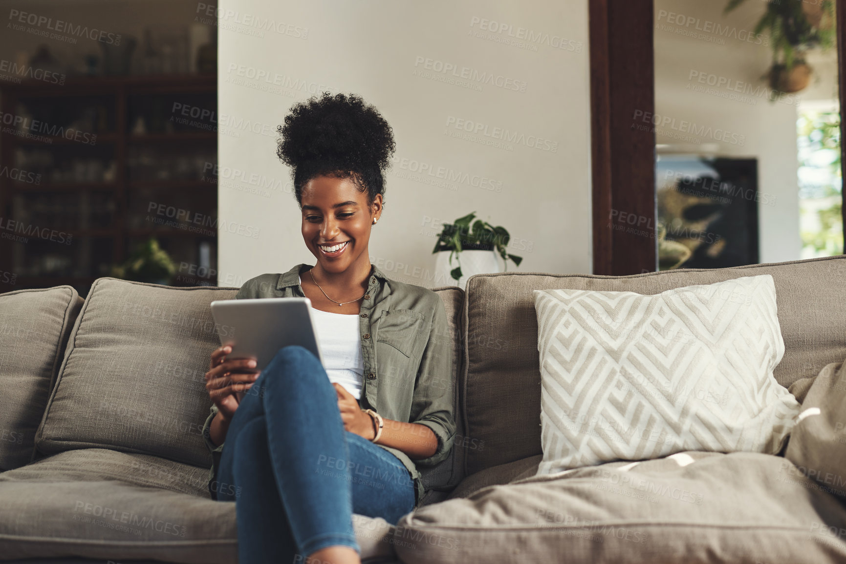 Buy stock photo Black woman, tablet and smile in home for relax, social media and streaming video on sofa with app. Female person, technology and happy in house for online comfort, website and digital painting