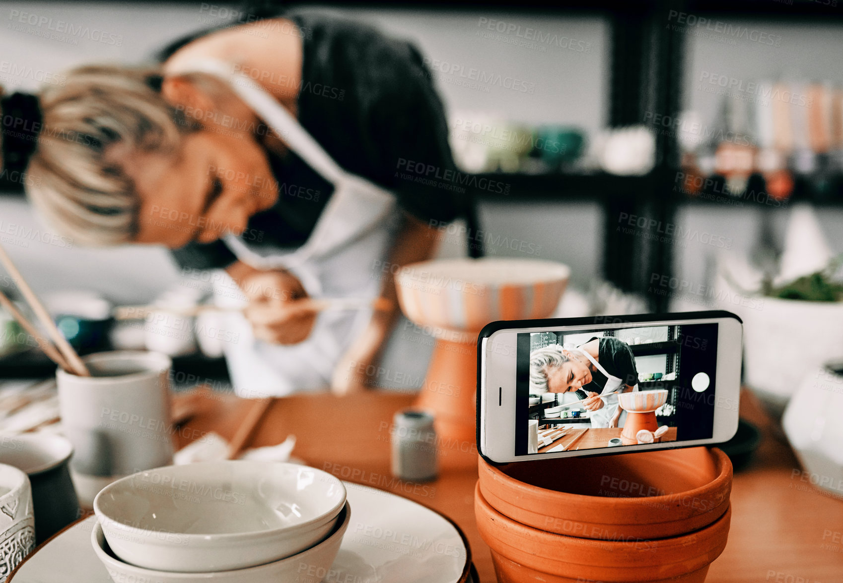 Buy stock photo Woman, phone and pottery in studio for art, painting and creative workshop with recording of process. Artist, smartphone and ceramics for small business, live streaming and video as online course