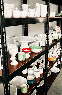 Buy stock photo Cropped shot of a potter's ceramic collection neatly arranged on a shelf in her studio