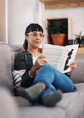 Buy stock photo Living room, reading and woman with story on sofa in home with smile for calm, peace and self help literature. Happy, rest and person on sofa with non fiction book for psychology knowledge in house.