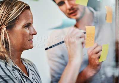 Buy stock photo Business woman, writing and planning with team on glass board for schedule, tasks or agenda at office. Female person, employee or planner taking notes with colleague for idea or reminder at workplace